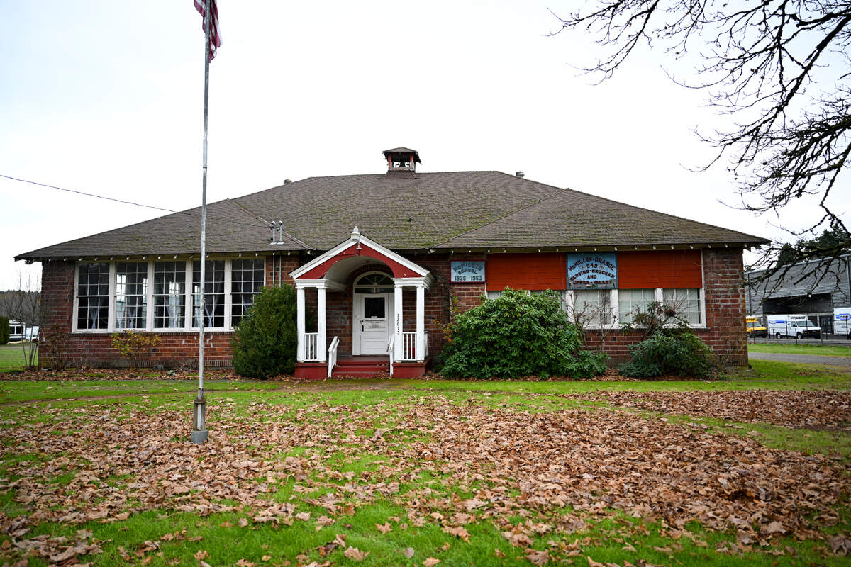 The McMillin Grange and its five maple trees have been just off WA-162 for nearly 100 years, Tuesday, Nov. 21, 2023, in Puyallup, Wash. A proposed roundabout at WA-162 and 128th St E.intersection would affect the Grange and the nearby neighbors.