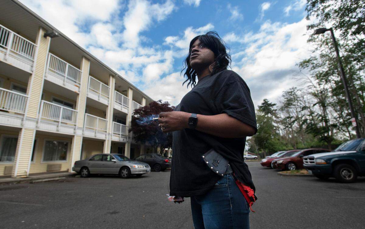 Janelle Wright carries a pair of hatchets on her hip while working her job as head housekeeper at the HomeTowne Studios hotel on Hosmer Street in Tacoma, Washington on July 8, 2022.
