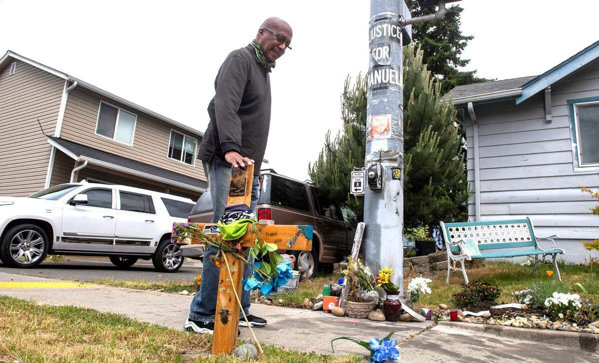 Billy Williams stops by the site in southeast Tacoma on Thursday, May 27, 2021, where Manuel Ellis died while in police custody to pay his respects after hearing that the state’s attorney general will charge police officers in Ellis’ death. “From what I’ve seen and what I’ve heard, it was the right decision,” Williams said. (AP PHOTO/Tony Overman, The News Tribune)