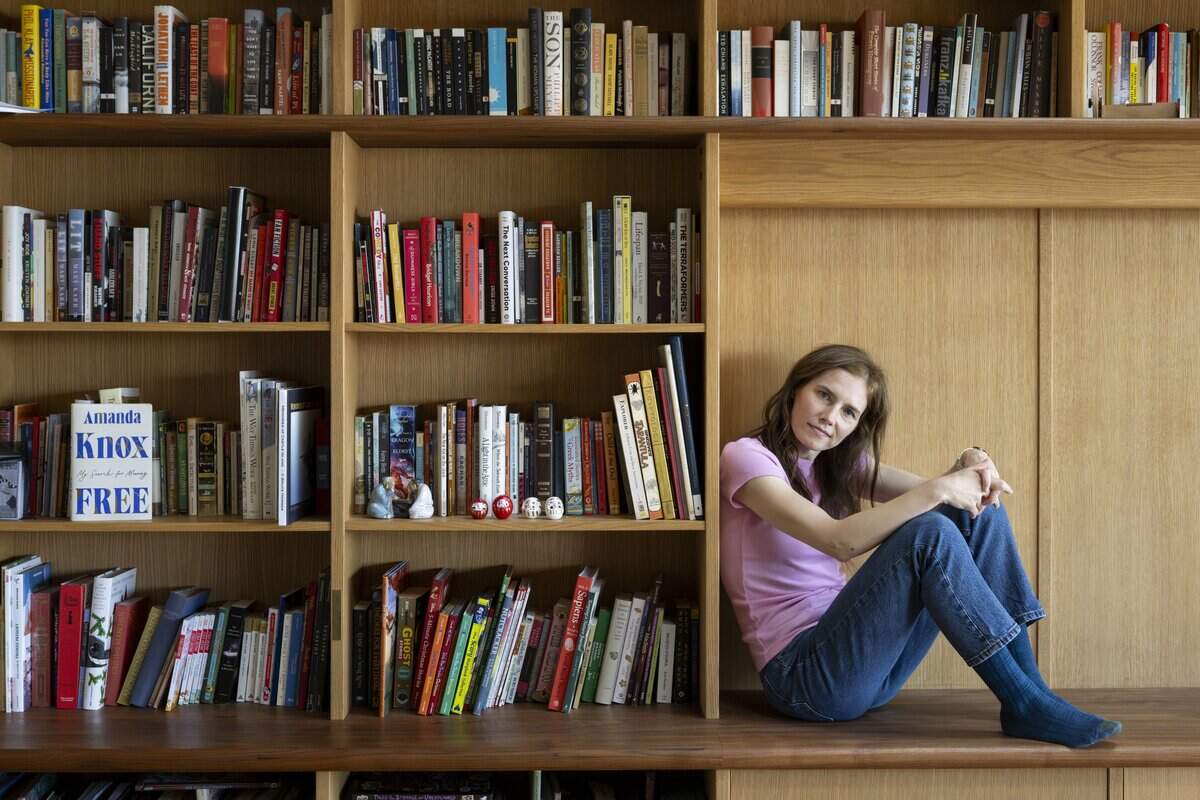 Amanda Knox poses for a portrait in her home on Tuesday, July 7, 2026, in Vashon, Wash. A copy of “Free: My Search for Meaning,” a memoir by Amanda Knox, is displayed on the bookcase.