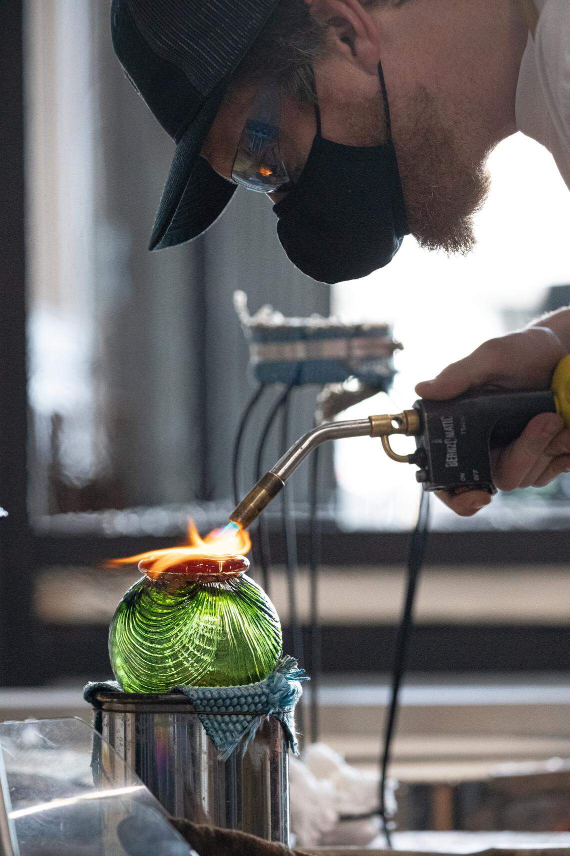 An anonymous artist makes a glass float for Monkeyshines 2022.