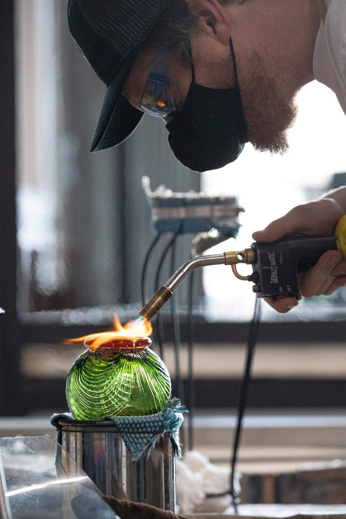 An anonymous artist makes a glass float for Monkeyshines 2022.