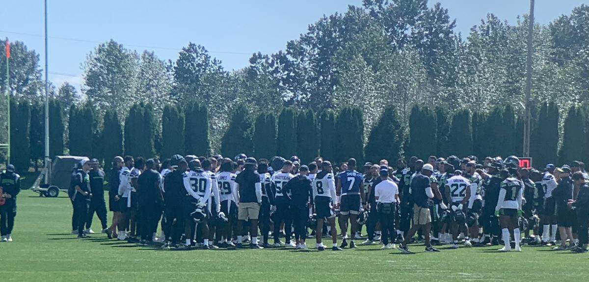 Coach Mike Macdonald gathers his Seahawks around him immediately following the first of three practices in the team’s mandatory NFL minicamp at the Virginia Mason Athletic Center in Renton June 11, 2024.