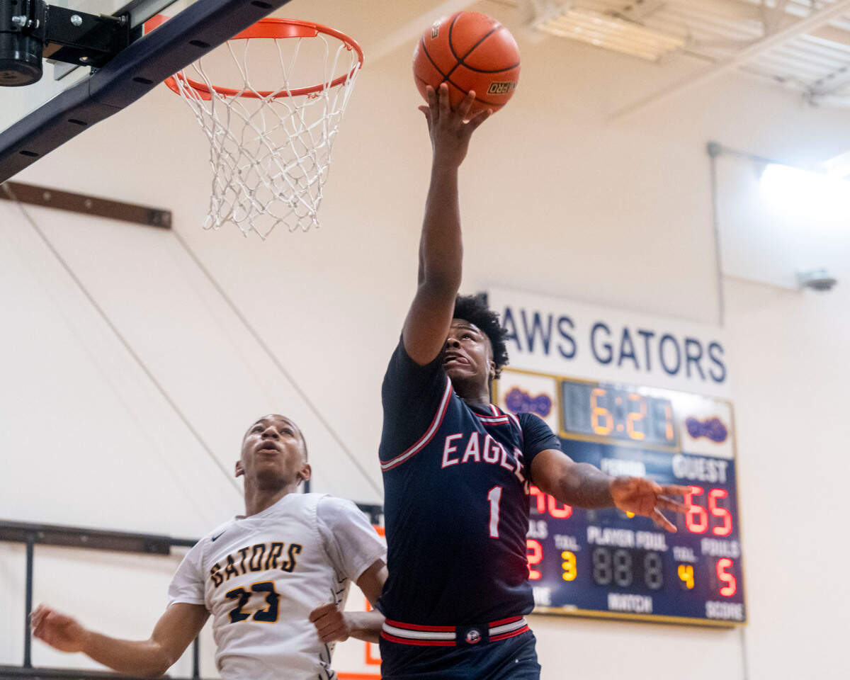 After grabbing a steal, Life Christian guard Daishaun Nichols (1) goes in for a layup as Annie Wright guard TJ Marshall (23) during the fourth quarter of a 1A Nisqually League game on Thursday, Feb. 10, 2022, at Annie Wright School in Tacoma, Wash.