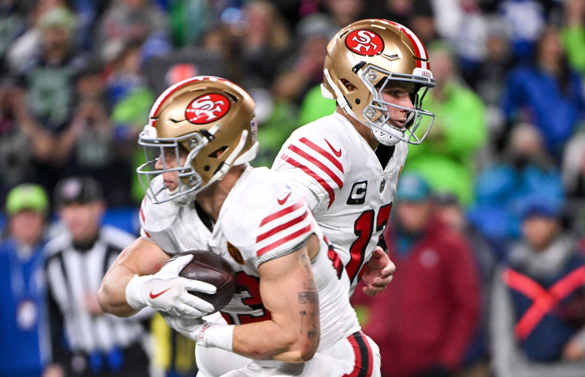 San Francisco 49ers quarterback Brock Purdy (13) hands off the ball to San Francisco 49ers running back Christian McCaffrey (23) during the first quarter of the game at Lumen Field, Thursday, Nov. 23, 2023, in Seattle, Wash.