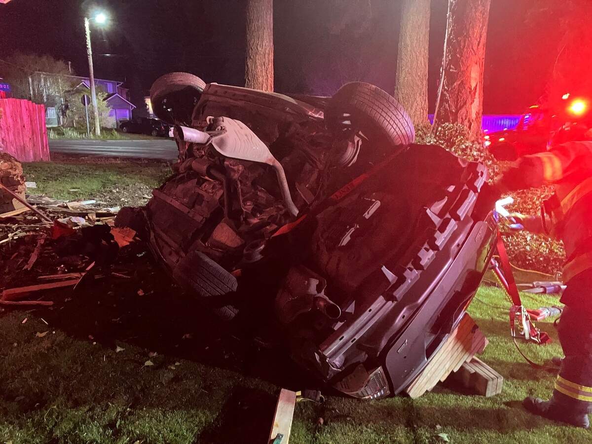 A vehicle lies on the yard of a property on 4600 block of 225th Street Court East in Spanaway. The collision left the female driver dead and the male passenger in critical condition.
