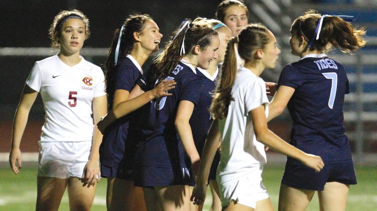 Gig Harbor’s Anna Stewart, center, is surrounded by teammates after scoring one of her two goals against Capital on Thursday, Oct. 18 at Roy Anderson Field.