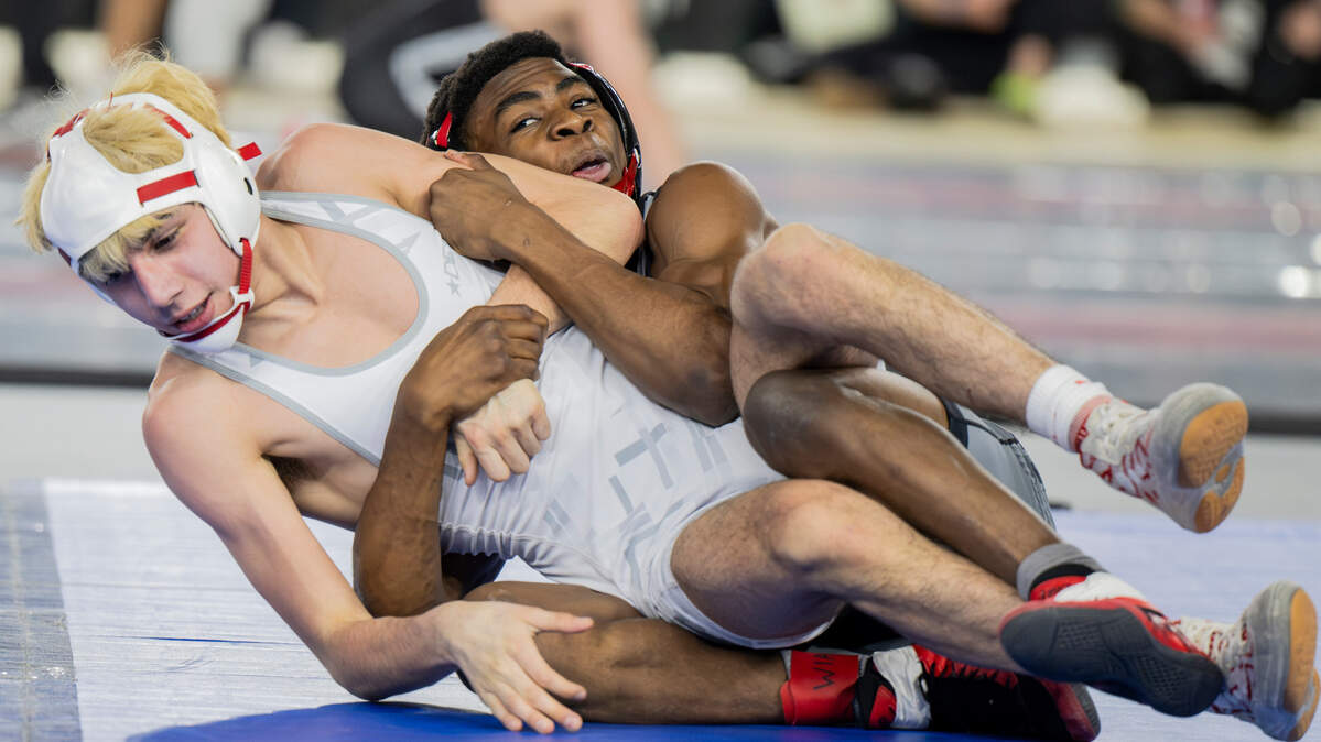 Orting’s Dominic Thomas rolls with Othello’s Isaac Campos in the 113-pound 2A championship match during day two of the Mat Classic XXXV at the Tacoma Dome on Saturday, Feb. 17, 2024, in Tacoma, Washington.