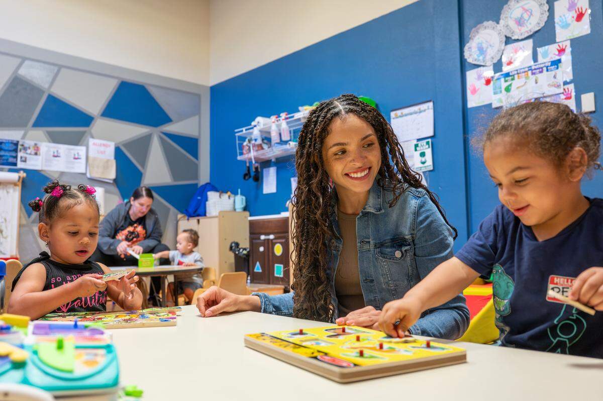 Addilyn, 2, left, works on a puzzle with teacher Morgan A., center, and fellow Early Head Start student Sebastian, 2, on Friday, May 9, 2025, at the Multicultural Child and Family Hope Center in Tacoma.
