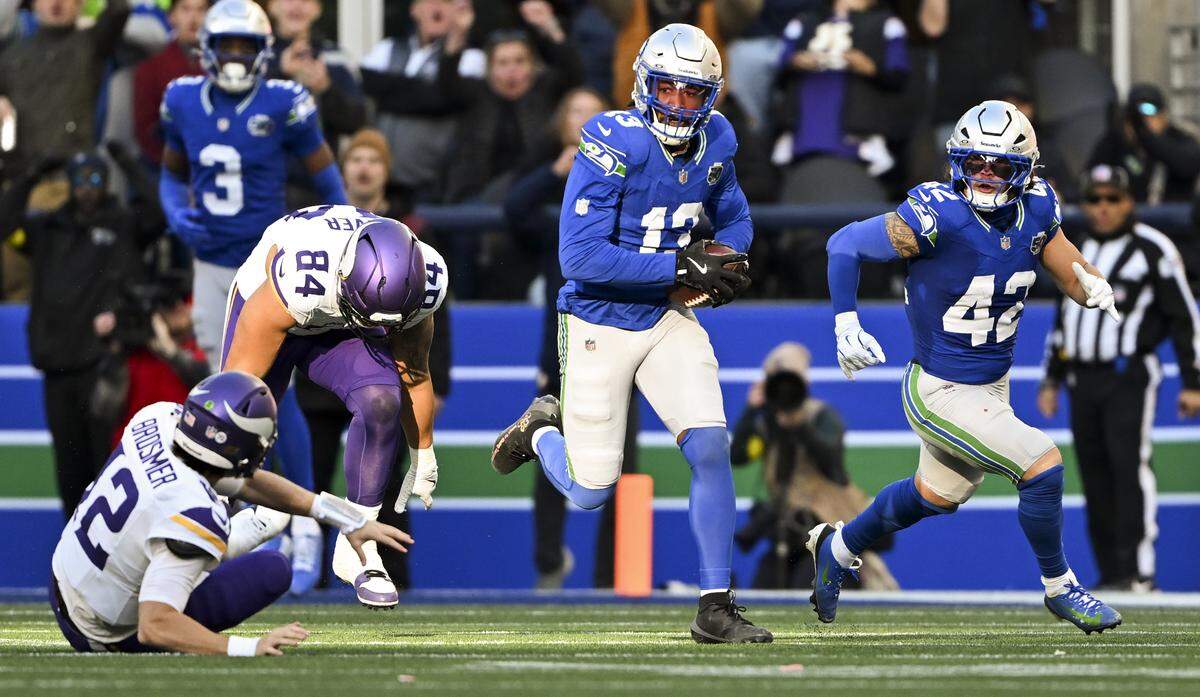 Seattle Seahawks linebacker Ernest Jones IV (13) runs back a 85-yard interception during the second quarter of the game against the Minnesota Vikings at Lumen Field, on Sunday, Nov. 30, 2025, in Seattle.