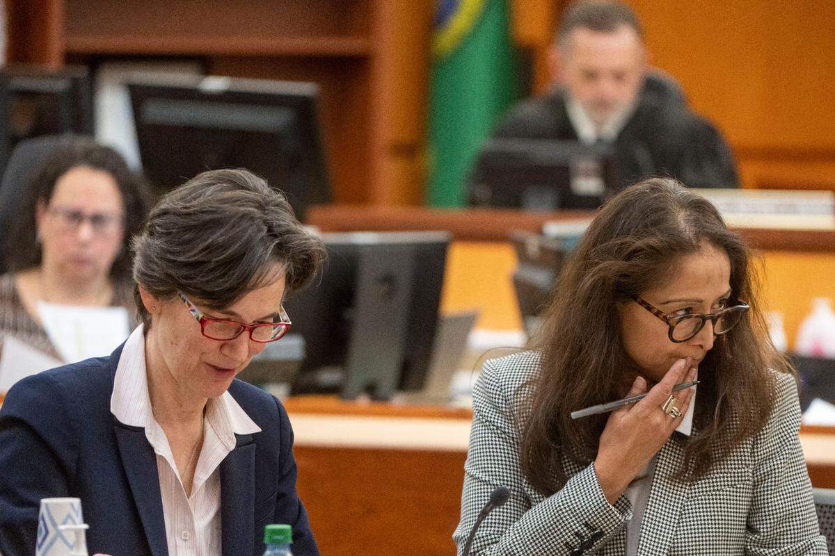 Washington state assistant attorney general Melanie Tratnik (left) and assistant attorney general Barbara Serrano deliberate over juror selection in Pierce County District Court on Wednesday, Nov. 30, 2022, in Tacoma, Wash.