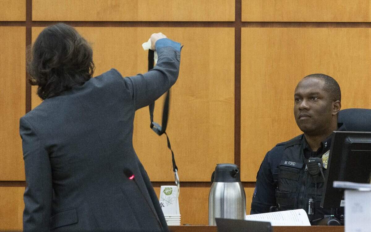 Special prosecutor Patty Eakes holds up hobbles as she cross-examines Tacoma police officer Masyih Ford in Pierce County Superior Court on Wednesday Nov. 15, 2023.