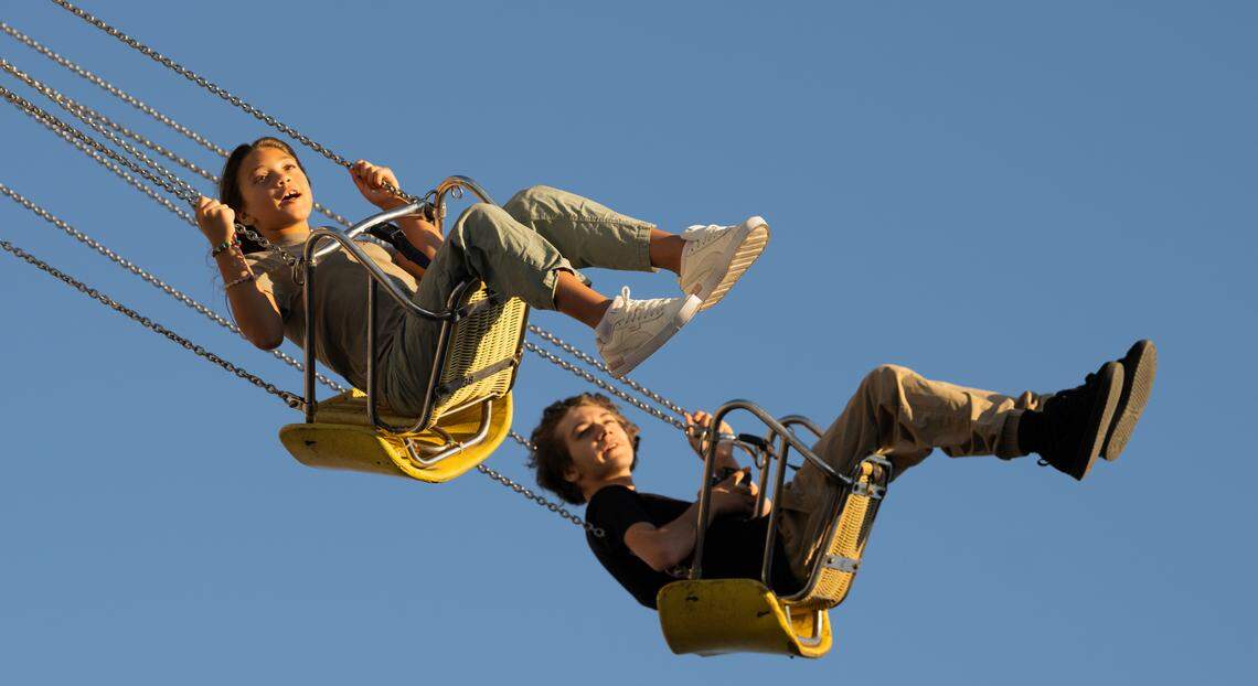 People ride the Wave Swinger during the opening day of the 2024 Washington State Fair.