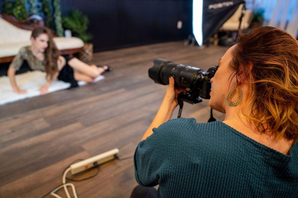 Jody Akerman takes pictures of a model during a boudoir photoshoot at her studio, Bright Eyes Photography, in downtown Puyallup, Wash., on Thursday, Oct. 20, 2022.
