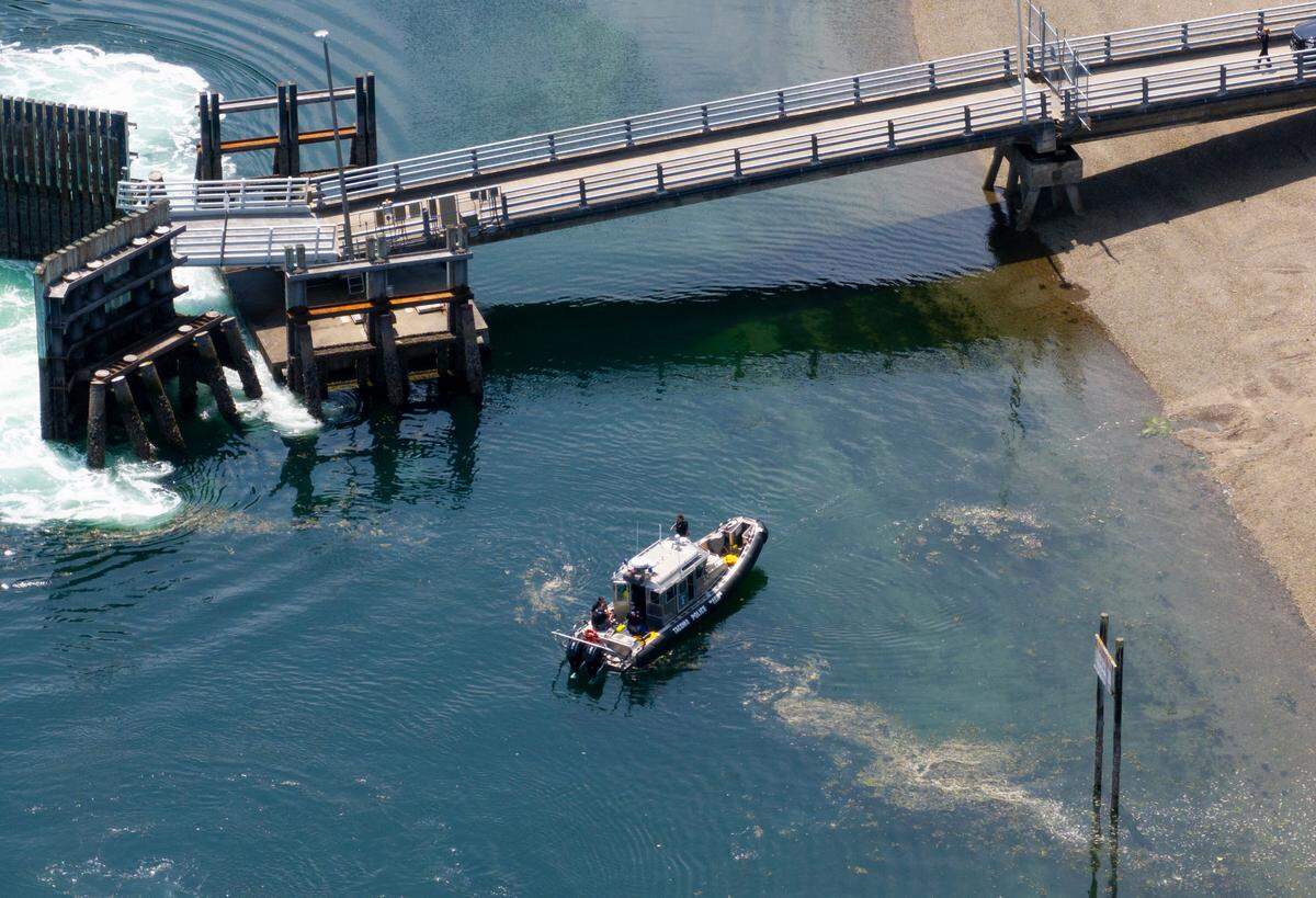 Emergency responders are seen Monday, June 23, 2025, on Ketron Island in Pierce County, Washington. Authorities searched the water after a man suspected of fatally stabbing his girlfriend Sunday drove his vehicle into Puget Sound.