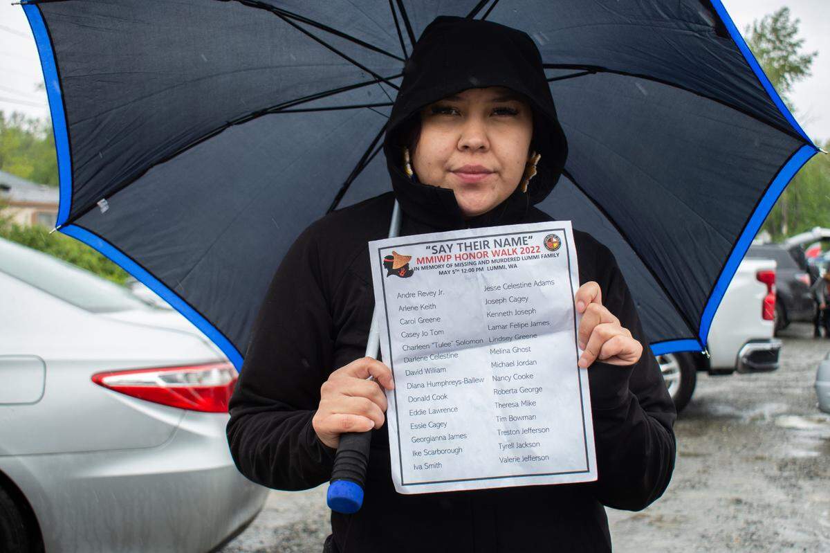 Santana Rabang, who is of Coast Salish and Stó:lō Nation heritage, holds a list of missing and murdered Lummi Tribal members at a gathering for Missing and Murdered Indigenous Women and People Awareness Day Thursday, May 5, on the Lummi Nation Reservation near Bellingham. Rabang led a group of Lummi Tribal members and the community in chanting the names as they marched down Haxton Way.