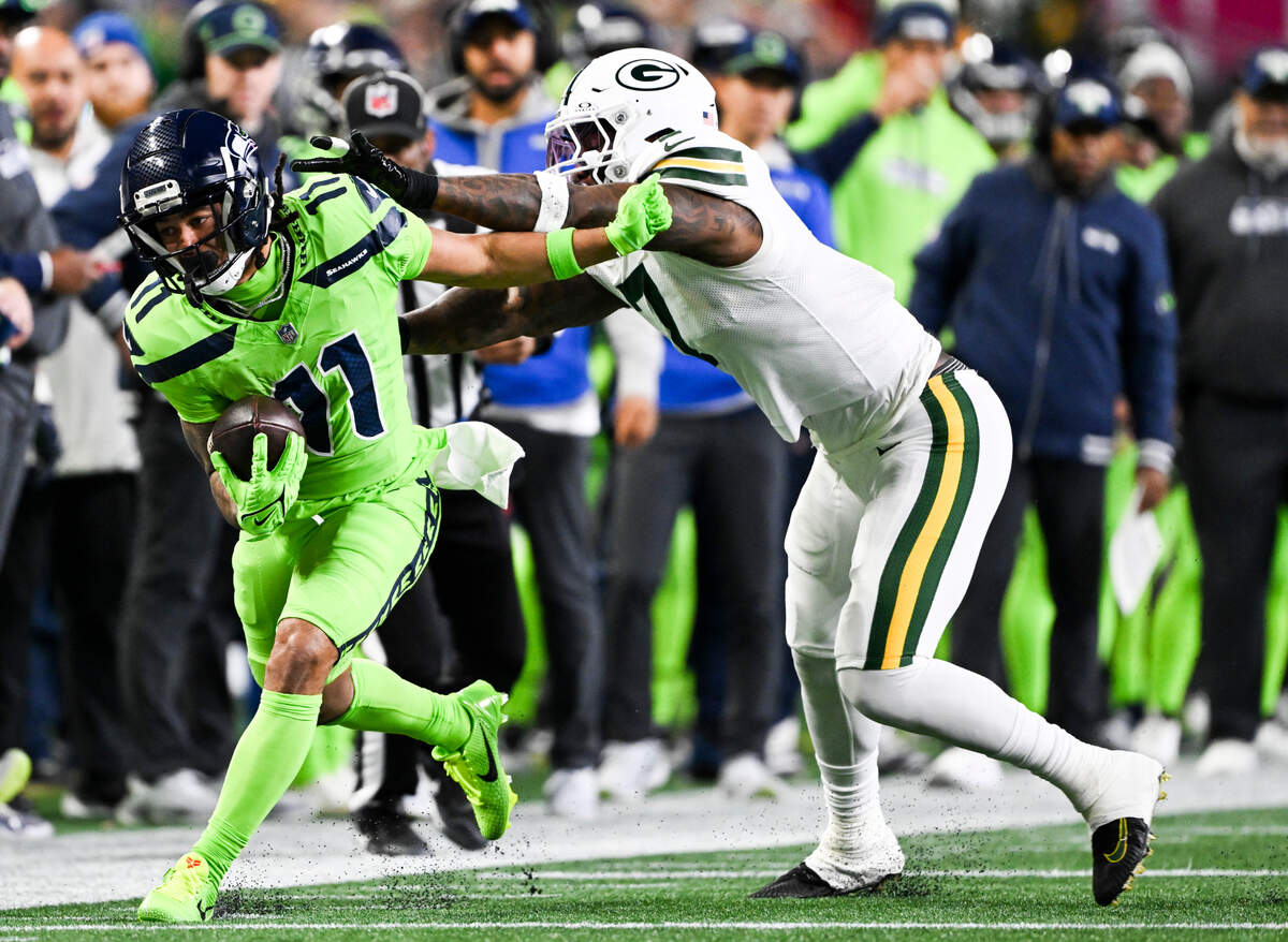 Seattle Seahawks wide receiver Jaxon Smith-Njigba (11) is knocked out of bounds by Green Bay Packers linebacker Quay Walker (7) during the second quarter of the game at Lumen Field, on Sunday, Dec. 15, 2024, in Seattle, Wash.