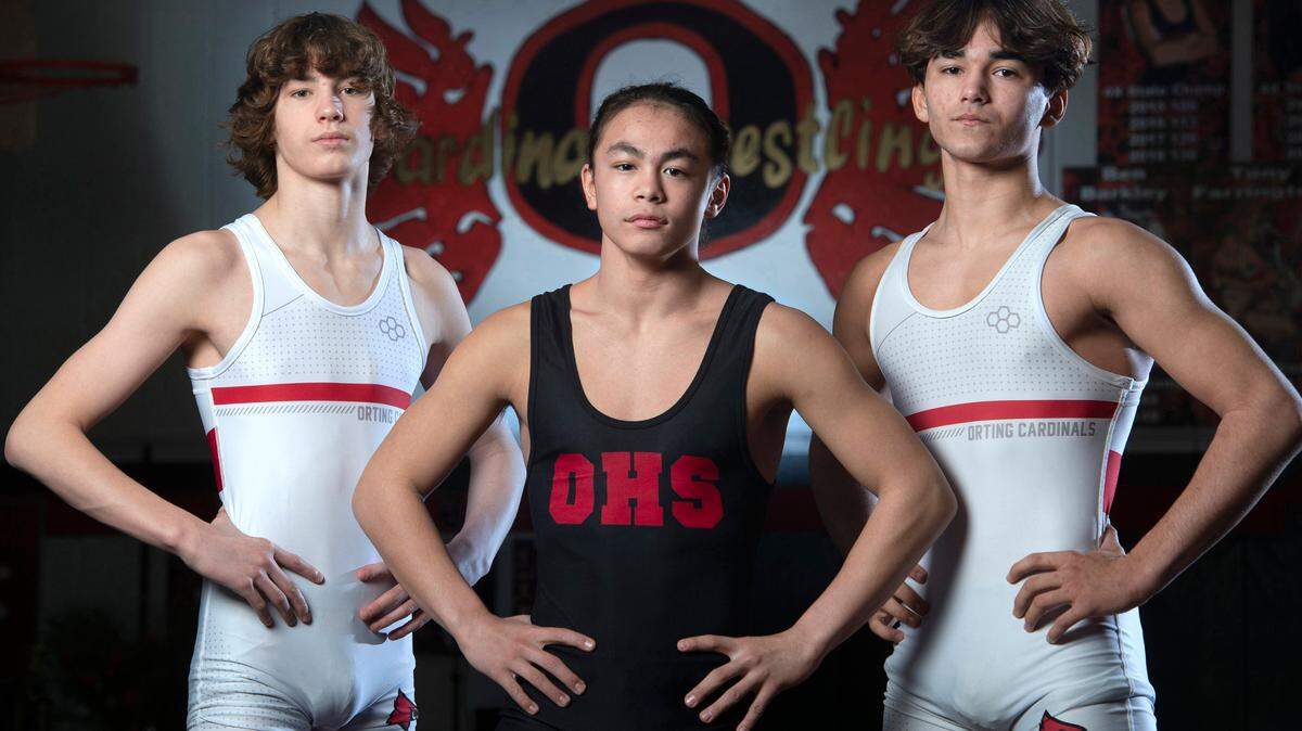 Orting wrestlers Quentin Harding (from left), Apollo Cruz and Owen Cline are leading the Cardinals. They are shown before wrestling practice at Orting High School in Orting, Washington, on Friday, Jan. 28, 2022.