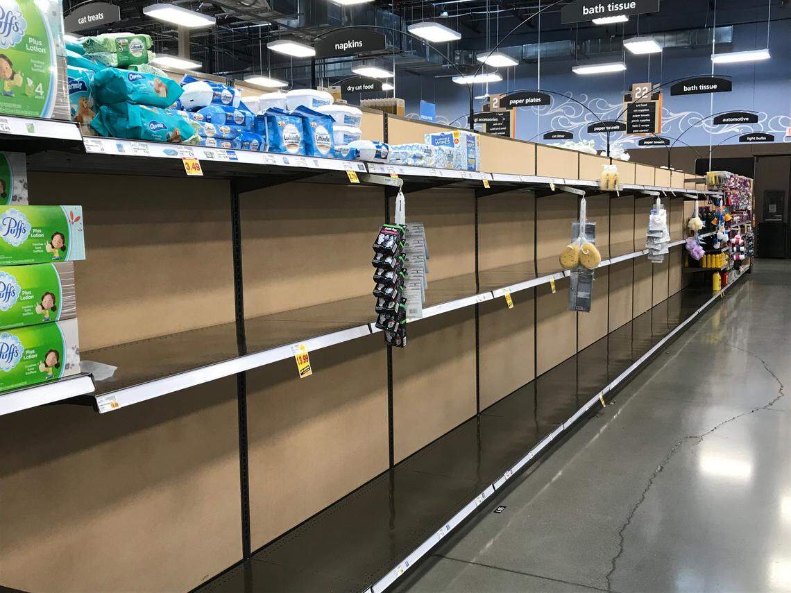 An aisle usually stocked with toilet paper was empty Tuesday at a Fred Meyer grocery in Gig Harbor, Washington. A weekend surge in shopping over coronavirus fears in the state left some stores hard hit for cleaning supplies.