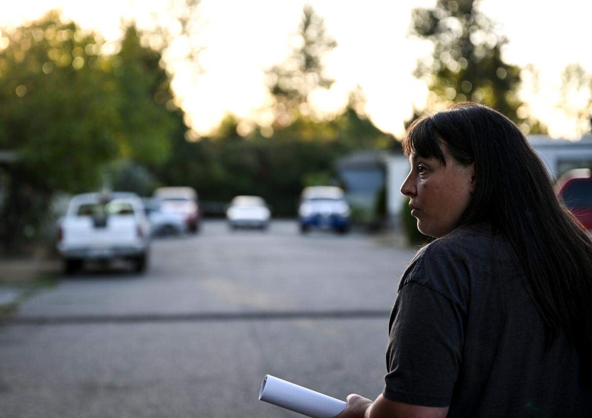 Natalee Lender, a resident, walks through the mobile home park where she and her husband have made a home at Cottonwood Mobile Home Park, Wednesday, Sept. 13, 2023, outside Puyallup, Wash. Shortly after Hurst & Son LLC purchased the mobile home park residents started receiving door hangers notifying them of a near 50% rent hike and new fees. The price hike has forced some to leave.
