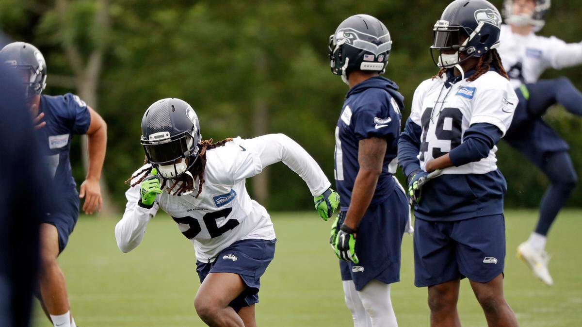 Seahawks starting cornerback Shaquill Griffin, left, starts a drill as his twin brother, rookie linebacker Shaquem Griffin (49) waits his turn during a practice during organized team activities Thursday in Renton.