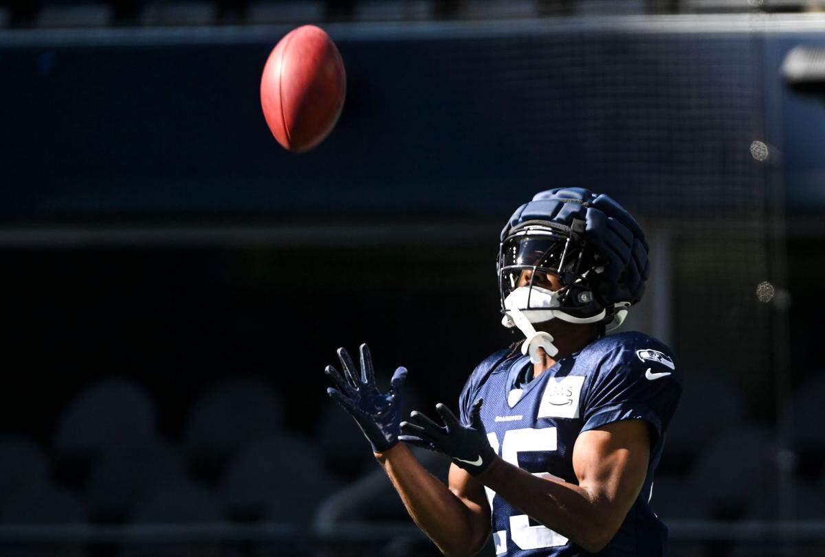 Seattle Seahawks running back Kenny McIntosh (25) catches the ball during warm-ups before the mock game at Lumen Field, Friday, Aug. 4, 2023, in Seattle, Wash.