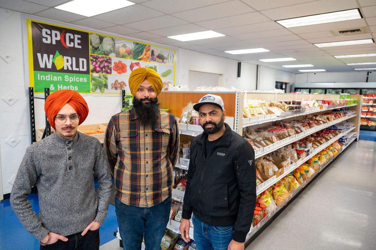 Owners of Spice World: Navjot Singh (left), Ravinder Singh (right) and Sukhwinder Singh pose for a portrait inside their store 10417 Canyon Road East in Puyallup, Wash., on Saturday, Feb. 25, 2023.