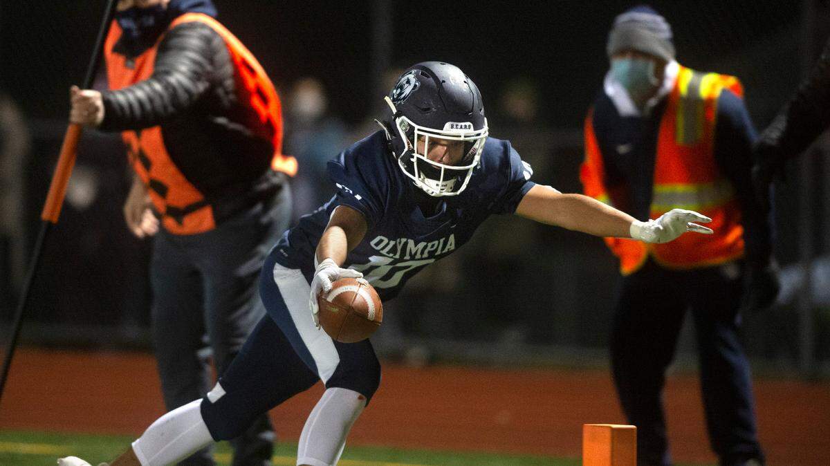 Olympia defensive back Alfredo Ramirez Cortes stretches for the goal line as he returns an interception during Friday nightÕs football game against Timberline at Ingersoll Stadium in Olympia, Washington, on Friday, Feb. 26, 2021. Olympia won the game 21-14 in overtime.