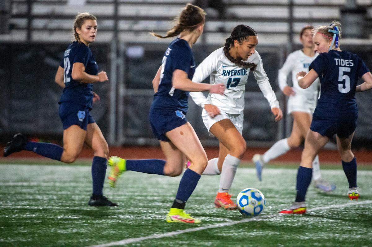 Auburn Riverside forward Samiah Shell dribbles through a trio of Gig Harbor defenders during the second half of the District 3/4 girls soccer championship game on Thursday night at South Sound Stadium in Lacey.