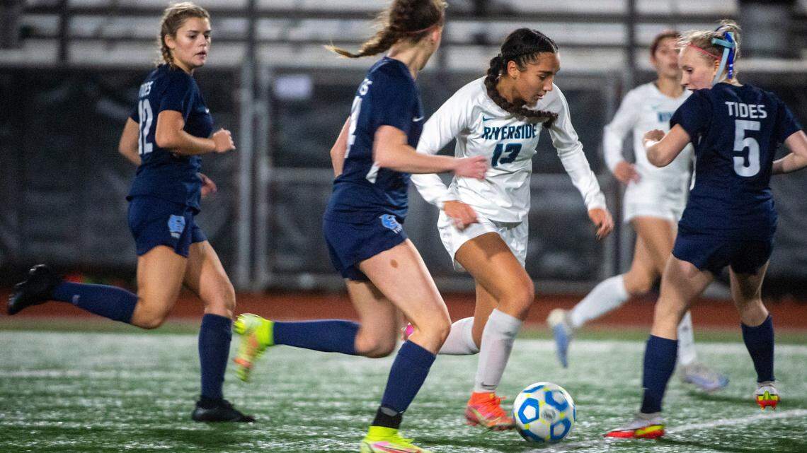 Auburn Riverside forward Samiah Shell dribbles through a trio of Gig Harbor defenders during the second half of the District 3/4 girls soccer championship game on Thursday night at South Sound Stadium in Lacey.