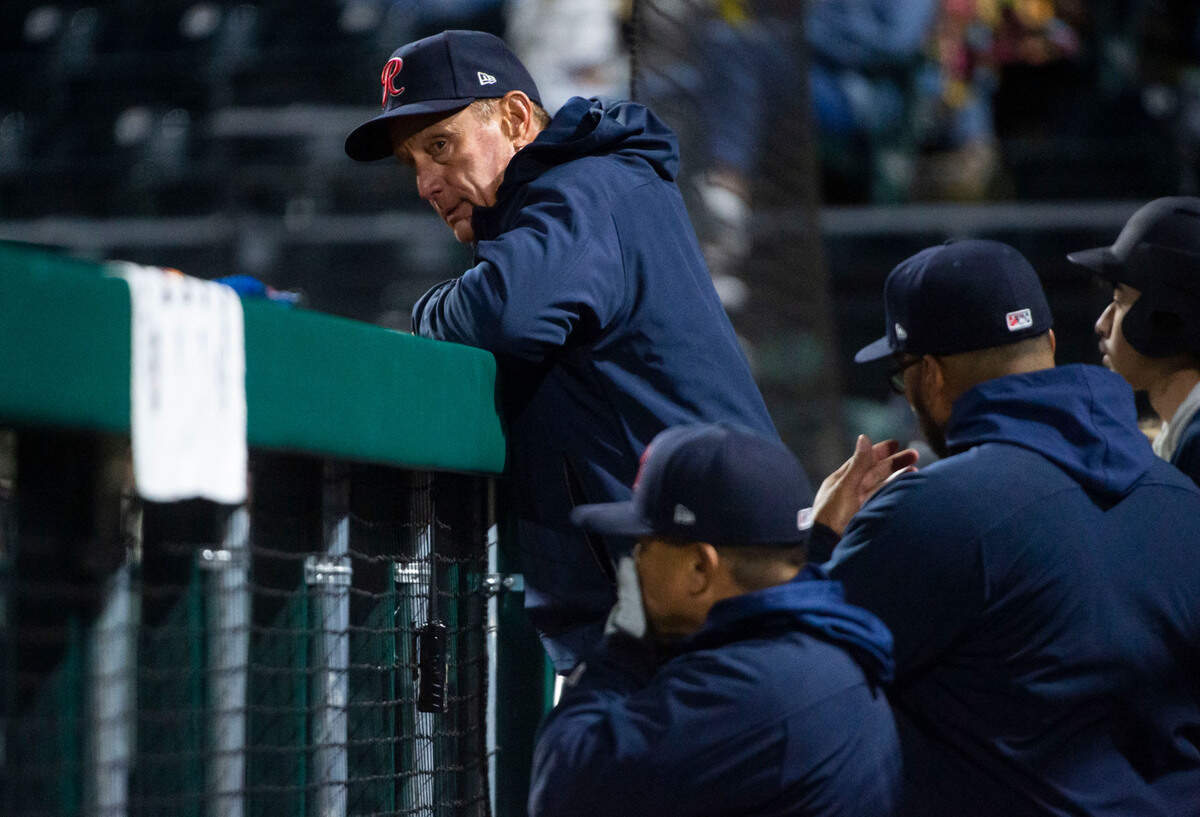 Tacoma Rainiers manager John Russell watches the game from the dugout during the seventh inning of the Rainiers home opener game against the Reno Aces at Cheney Stadium in Tacoma, Wash. on April 4, 2023.