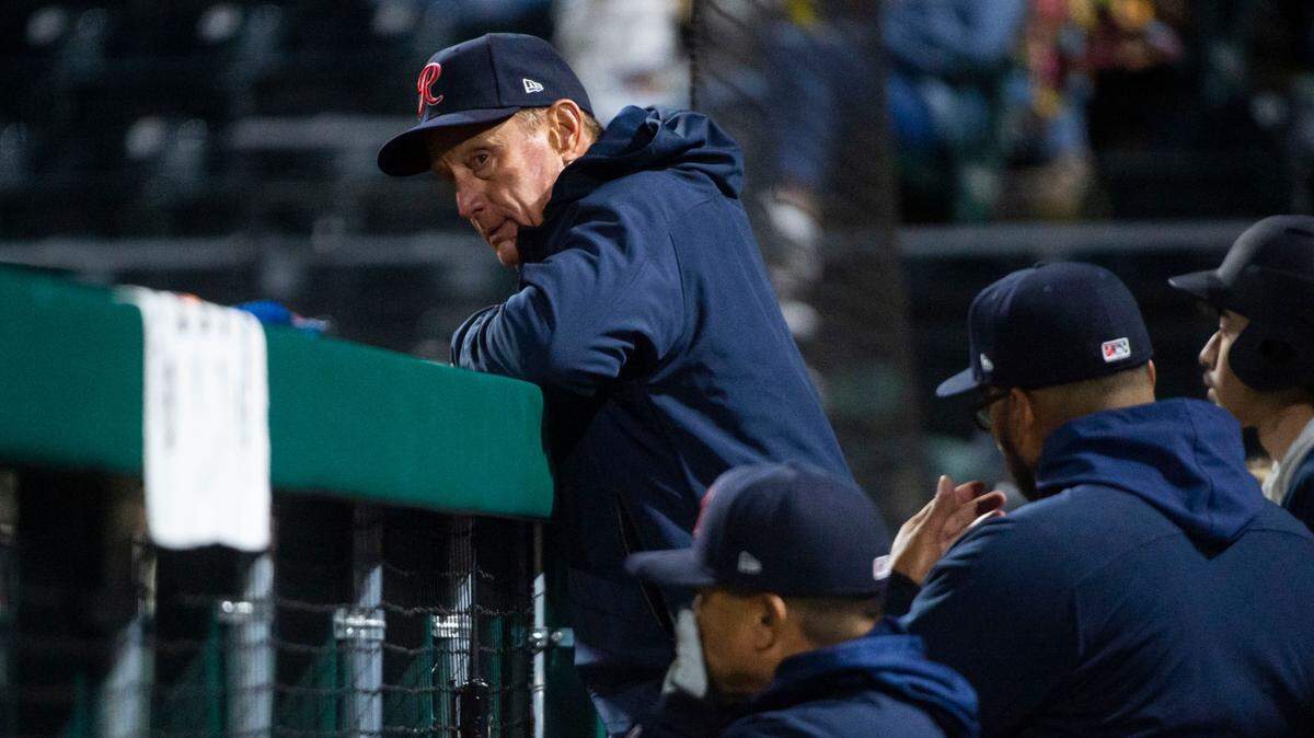 Tacoma Rainiers manager John Russell watches the game from the dugout during the seventh inning of the Rainiers home opener game against the Reno Aces at Cheney Stadium in Tacoma, Wash. on April 4, 2023.
