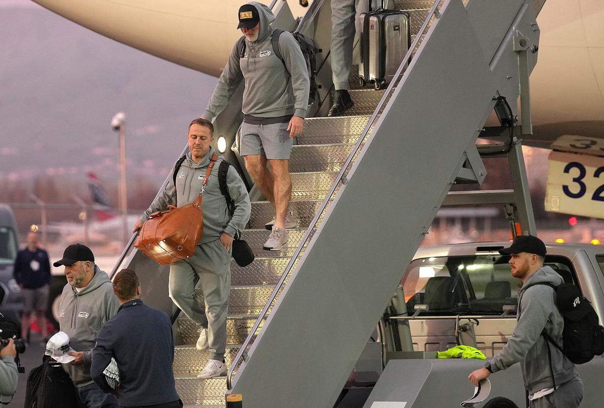 SAN JOSE, CALIFORNIA - FEBRUARY 01: Sam Darnold #14 of the Seattle Seahawks (bottom R) arrives with teammates at San Jose Mineta International Airport ahead of Super Bowl LX on February 01, 2026 in San Jose, California. (Photo by Thearon W. Henderson/Getty Images)