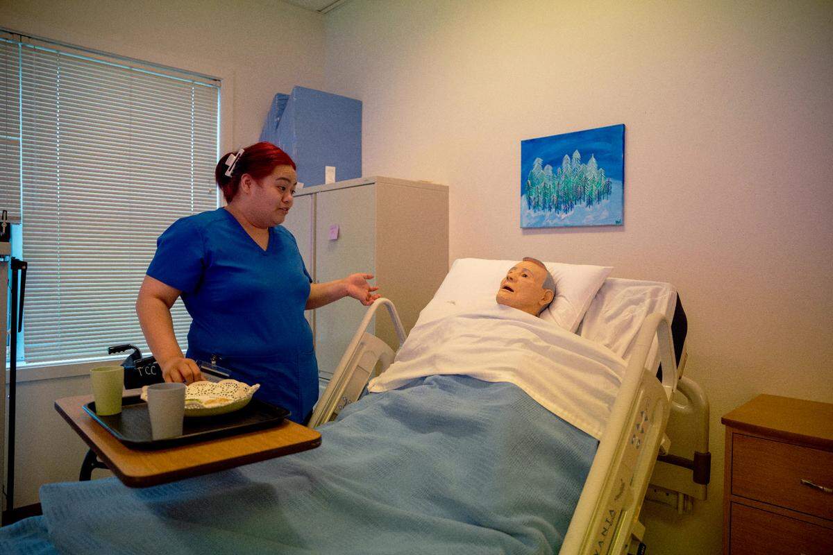 Tino Sagale who is a student at Tacoma Community college practices a feeding routine during one of their classes on Aug. 16, 2022 at Tacoma Community College