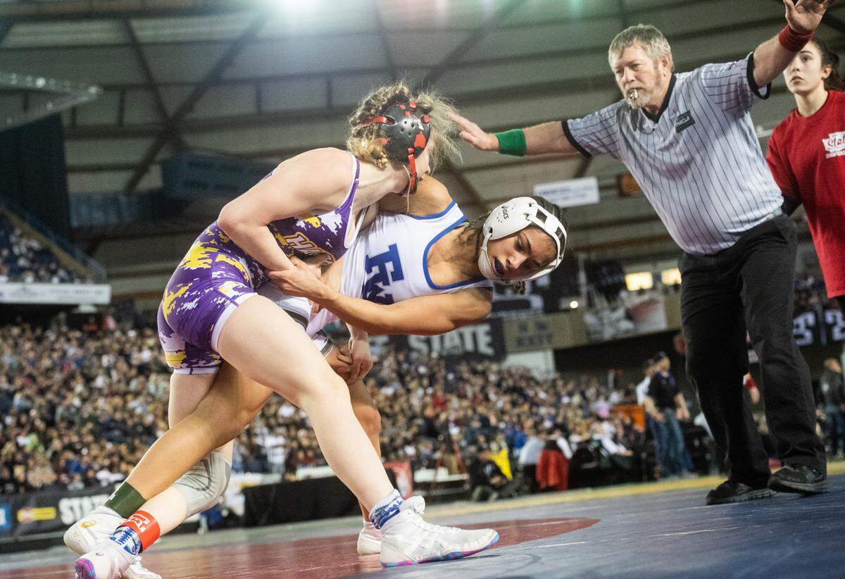 Hanford’s Taylor Wilson grapple during a girls championship at Mat Classic XXXII in February. She was ranked fourth among the best girl wrestlers in the state.