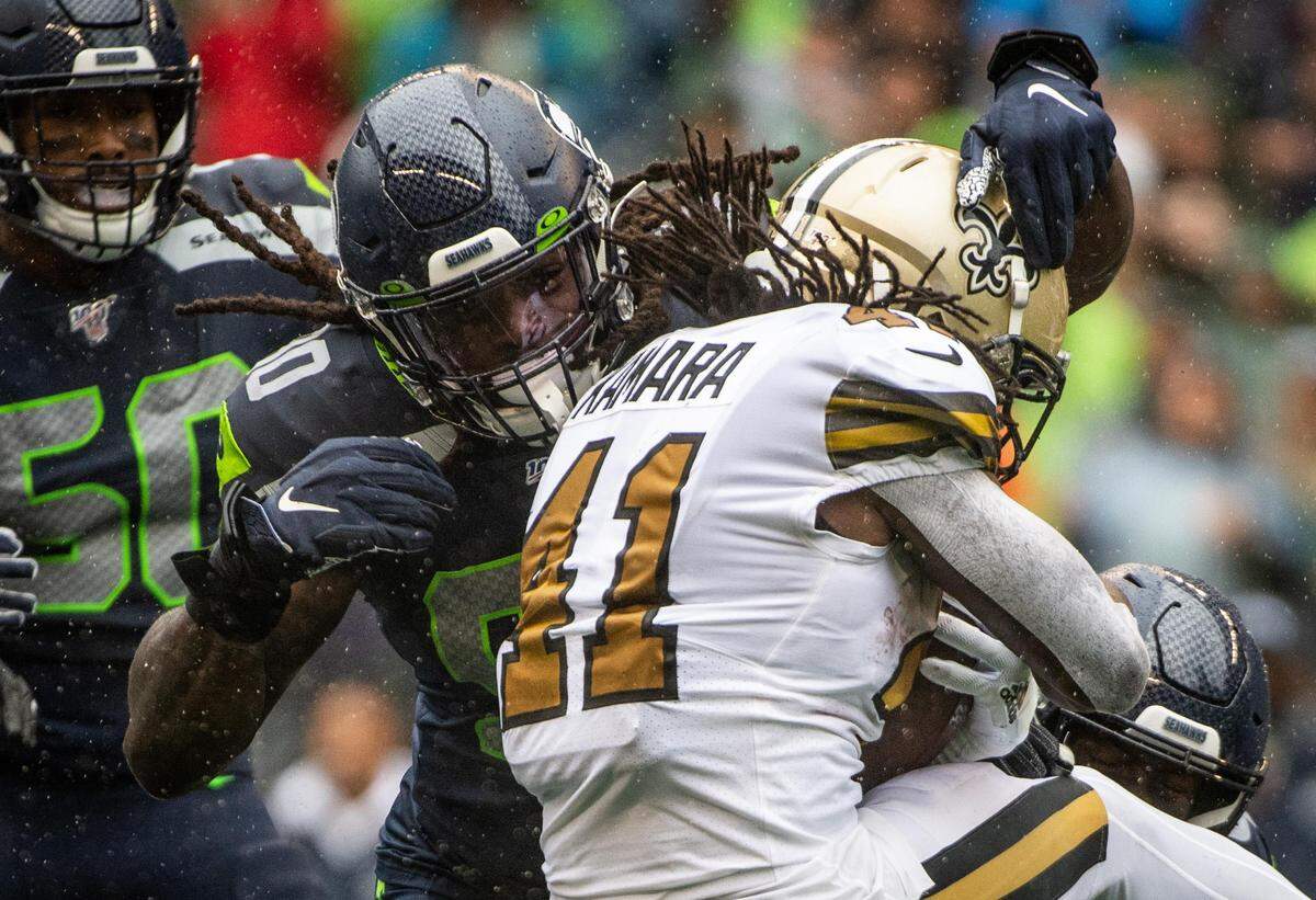 Seattle Seahawks outside linebacker Jadeveon Clowney (90) tackles New Orleans Saints running back Alvin Kamara (41) during the second quarter. The Seattle Seahawks played the New Orleans Saints in a NFL football game at CenturyLink Field in Seattle, Wash., on Saturday, Sept. 21, 2019.