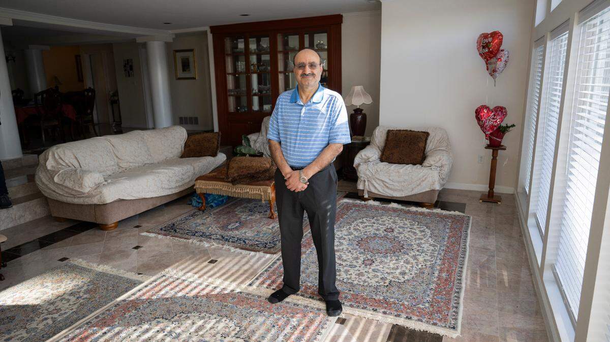 Ebrahim Mirjalil poses for a portrait in his home on Tuesday, April 2, 2024, in Lakewood. Mirjalil and his family had lived in their home on Lake Steilacoom Lake since 2008 before it was demolished by the city as part of upgrades to Edgewater Park.