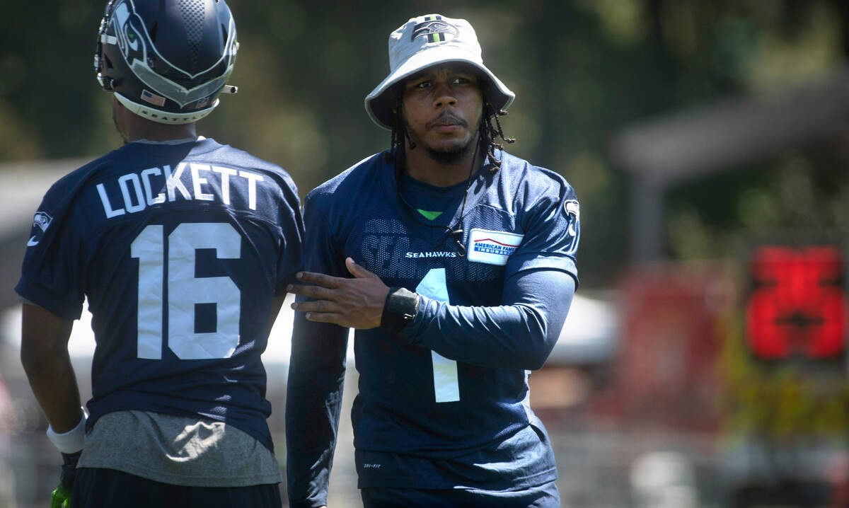 Seahawks wide receiver Wayne Eskridge passes teammate Tyler Lockett during practice at the Virginia Mason Athletic Complex in Renton, Washington, on Thursday, July 29, 2021.