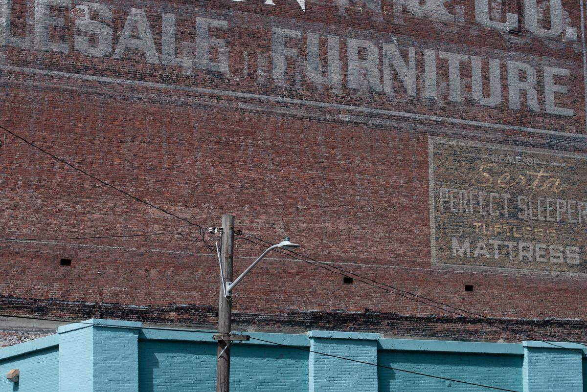 The ghost signs under the comparatively new painted “The Harmon” sign at 1944 Pacific Ave. in Tacoma. Photo taken on July 12, 2023.