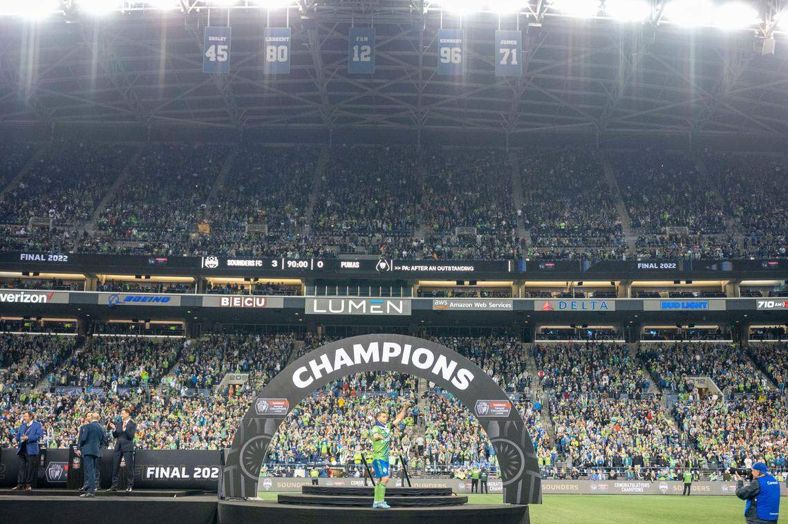 Seattle midfielder Nicolás Lodeiro (10) holds up an award he received for the tournament after the Sounders beat Pumas, 3-0, to win the CONCACAF Champions League Final at Lumen Field in Seattle, on Wednesday, May 4, 2022.