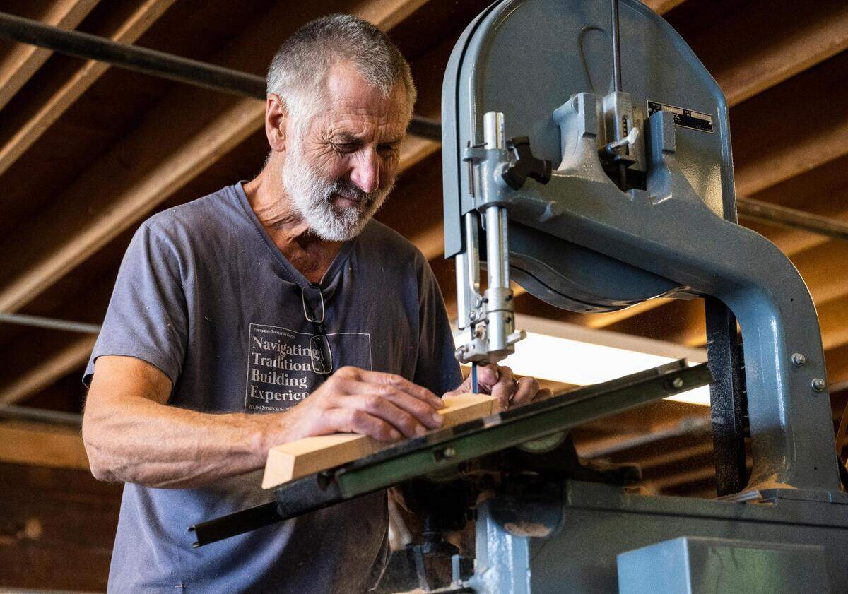 Anthony “Mike” Vlahovich cuts a board for a Croatian fishing boat that is being built as part of “The Batana Project” at the Gig Harbor Boat Shop in Gig Harbor, Wash. on Wednesday, July 20, 2022. Once the boat is complete, the boat shop will host an event to reveal it Sept. 3.
