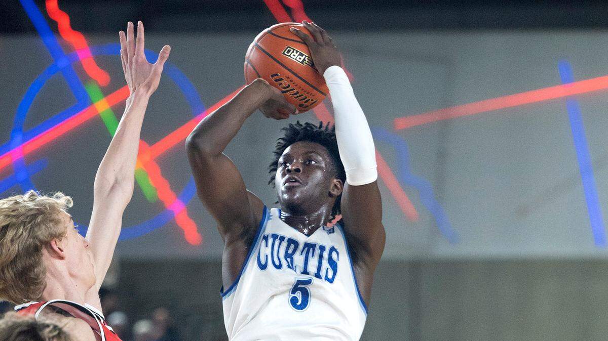 Curtis’s Zoom Diallo puts up a jumper over Camas defender Matthew Sitler during their state quarterfinal game at the WIAA state basketball tournament in the Tacoma Dome in Tacoma, Washington, on Wednesday, March 1, 2023. Curtis won the game, 73-46