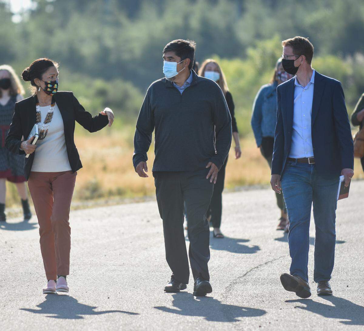 U.S. Interior Secretary Deb Haaland, left, Quinault Indian Nation President Guy Capoeman and U.S. Rep. Derek Kilmer leave the Quinault tribe’s new housing development being built out of a tsunami zone. Haaland and Kilmer met with Washington state tribal leaders to discuss rising sea levels, community relocation and broadband access Monday, Aug. 9, on the Quinault Indian Reservation in Taholah, Wash. The group toured the Village of Taholah to see first-hand the effects of rising sea levels on coastal tribal communities.