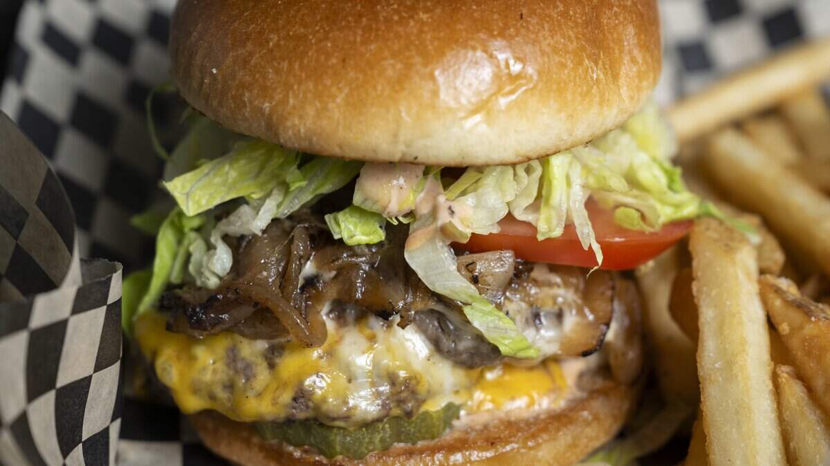A True Smash Burger is served with fries at The Edit Social House on Thursday, May 21, 2026, at the Oakbrook Golf Club in Lakewood, Wash.