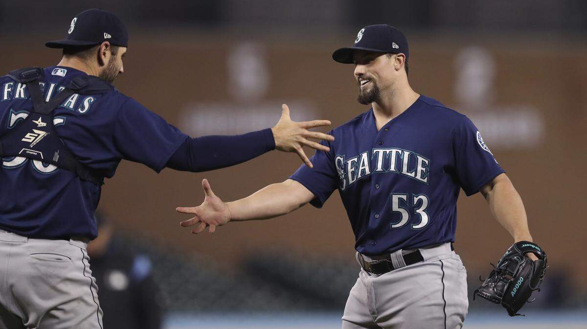 Seattle Mariners relief pitcher Dan Altavilla (53) and catcher David Freitas celebrate the team’s 9-5 win over the Detroit Tigers in the second game of a baseball doubleheader Saturday, May 12, 2018, in Detroit.