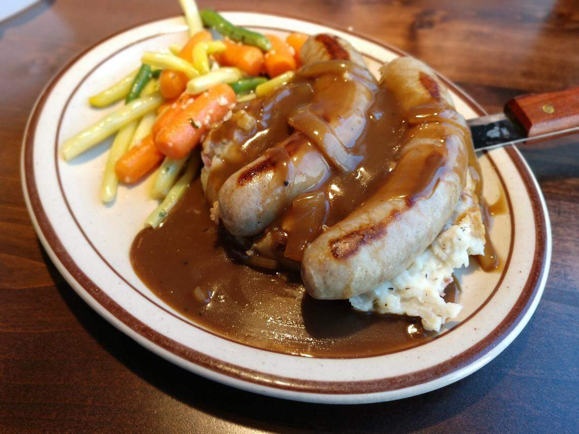 Bangers and mash with mashed potatoes and vegetables from Oddfellas Pub & Eatery in Tacoma.
