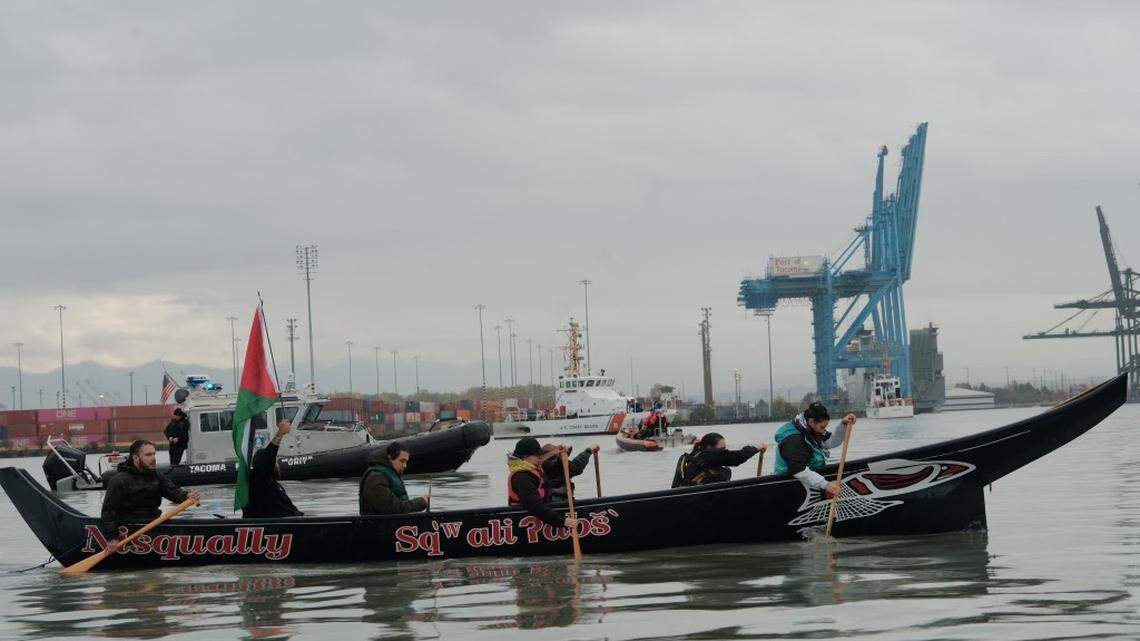 Coast Salish water warriors aboard a traditional Nisqually canoe paddle into the Port of Tacoma in an effort to block the MV Cape Orlando from leaving the port, on Monday, Nov. 6, 2023.
