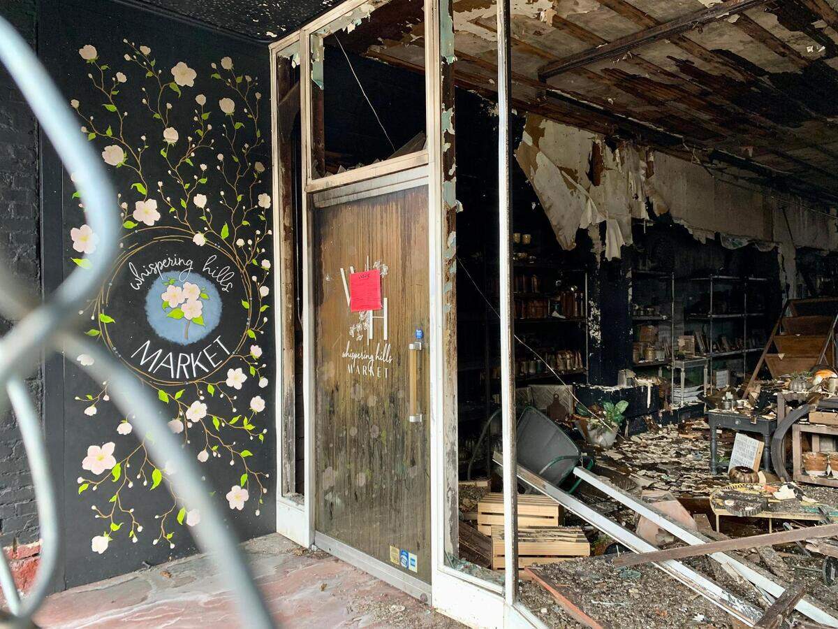 Whispering Hills Market, 1003 Main St. in Sumner, Wash., was one of several downtown businesses devastated by the Oct. 28 three-alarm fire. A red sign on the entrance warns of the dangerous integrity of the structure, which has been declared a total loss.
