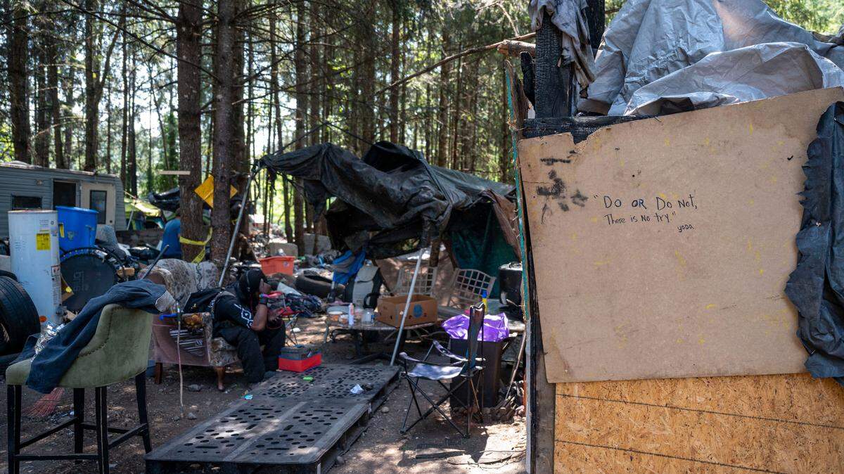 Make-shift shacks and RVs are scattered around the wooded area along the 9700 block of Steele Street South where a medium-sized homeless encampment has existed on-and-off for over five years in Tacoma. Photographed in June 2023.