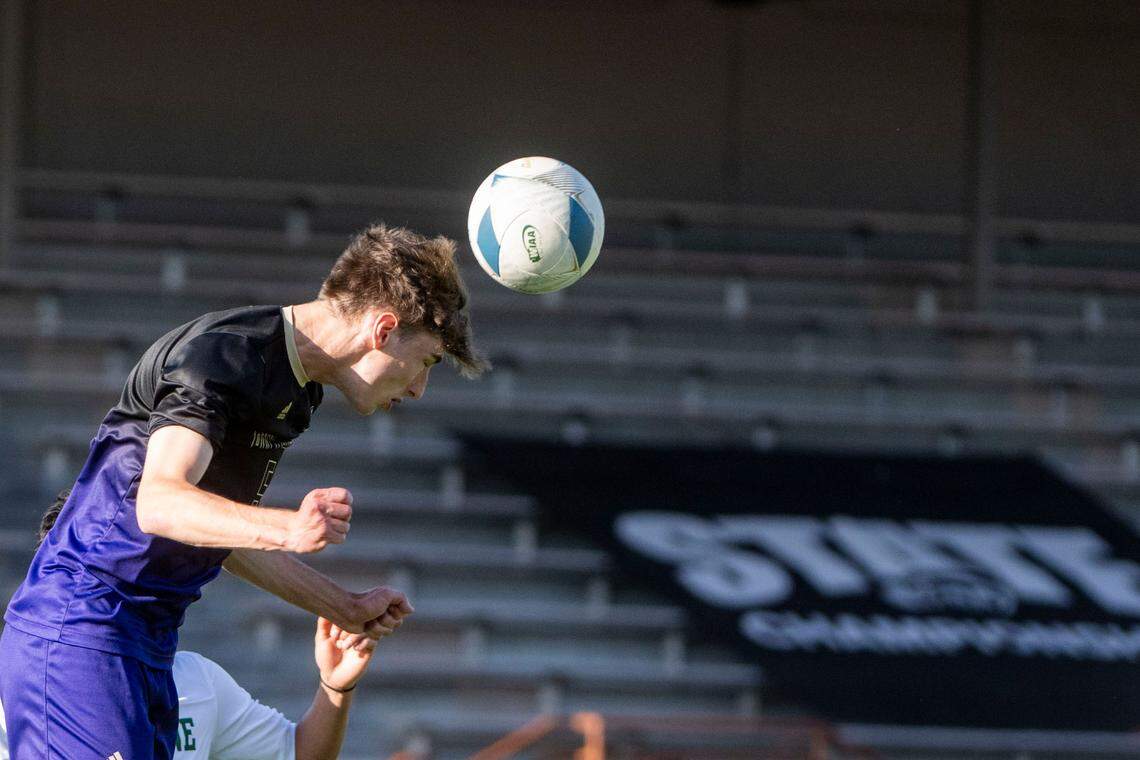 Puyallup defender Brady Anderson heads the ball out of the penalty area during the first half of the Class 4A state championship game against Skyline on Saturday, May 27, 2023, at Sparks Stadium in Puyallup, Wash.